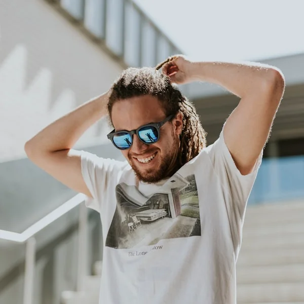 Man with a styled haircut and sunglasses