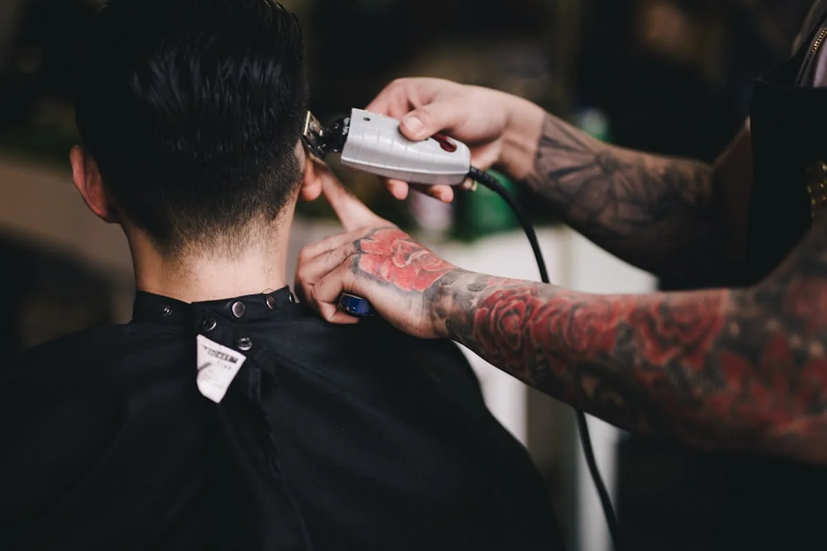 Barber using clippers for a clean neckline