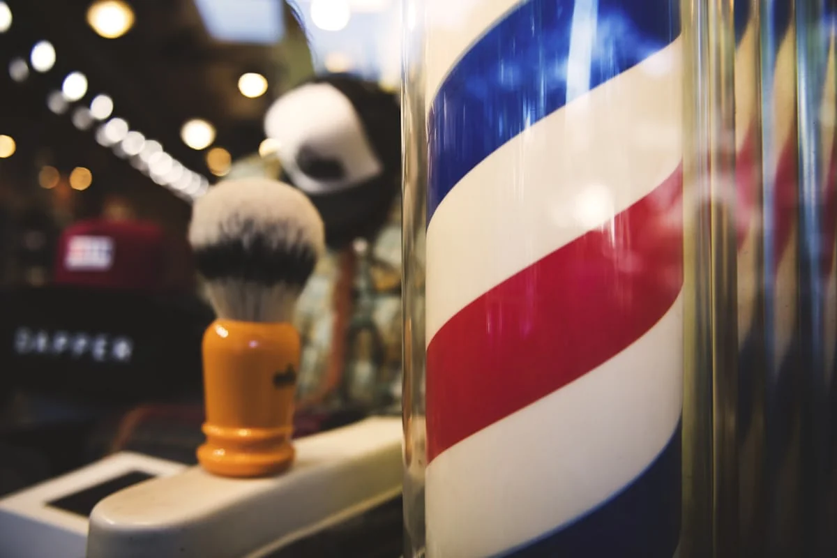 Traditional barbershop pole and shaving brush