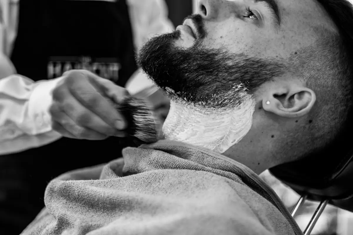 Barber shaping a client’s beard