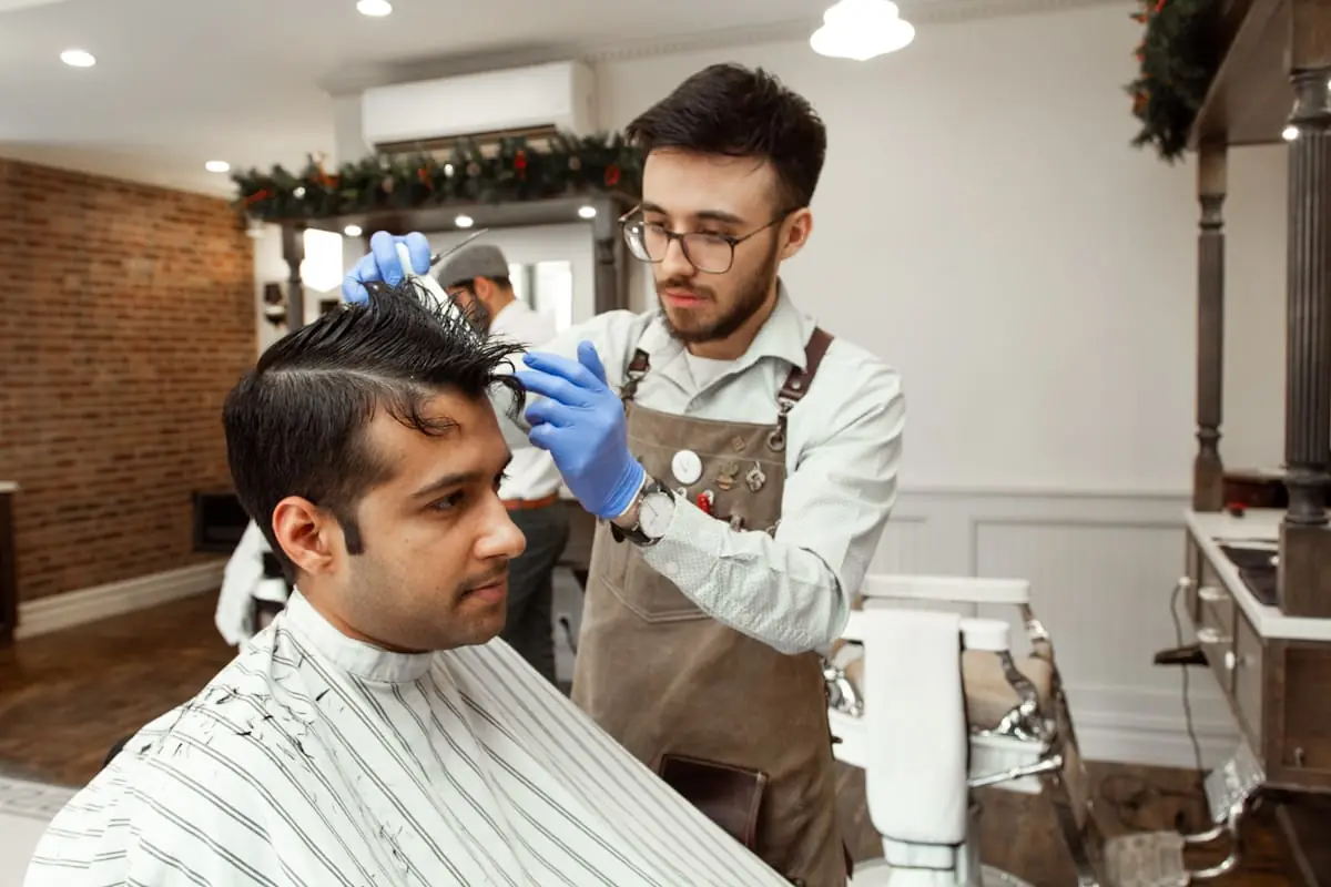 Barber cutting hair in the shop